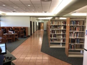 During library hours, you may also enter from the second floor of the library. Follow the tile to the left rear and pass through two doors.