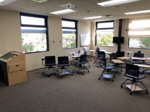 Collaboration Studio features a standard smart classroom podium, movable desks, and three monitors for group activities.